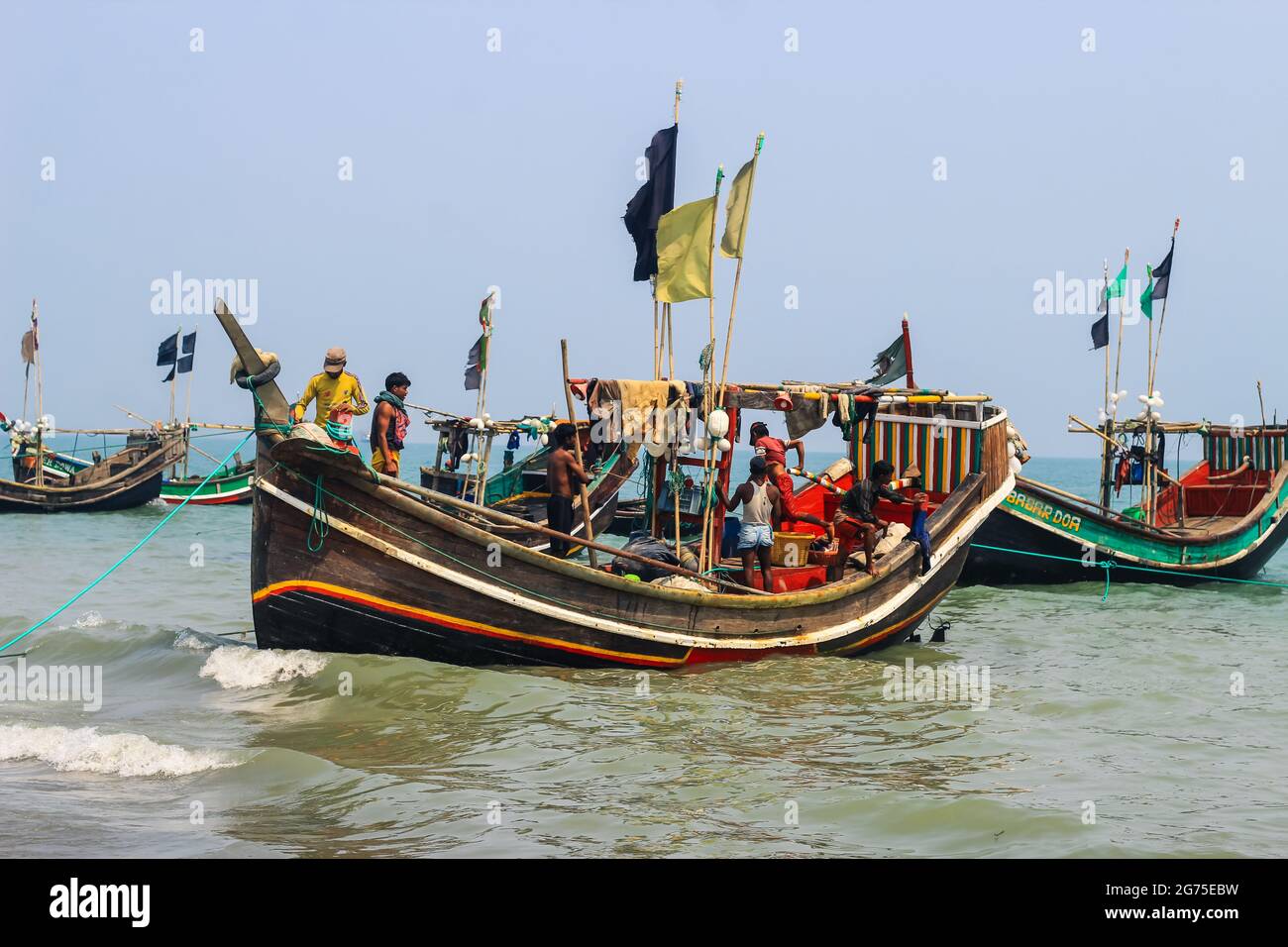 Fishermen and their colorful fishing boats. The fishing industry in