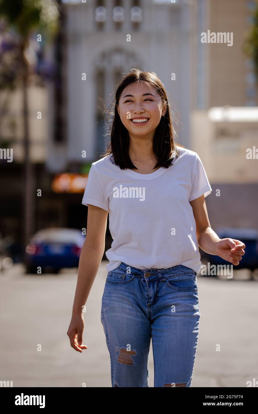 Portraits of Young Asian Woman Walking in a Downtown Parking Lot Stock Photo