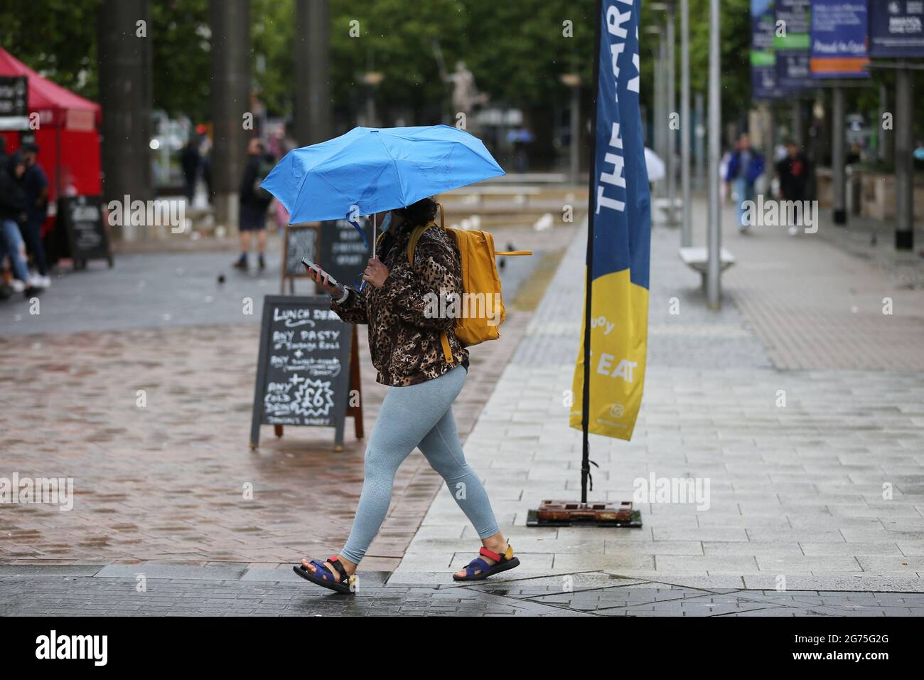 Bristol, UK, 11th July, 2021. UK Weather.Rain burst in Bristol city centre as people use their umbrellas.Credit: Gary Learmonth / Alamy Live News Stock Photo