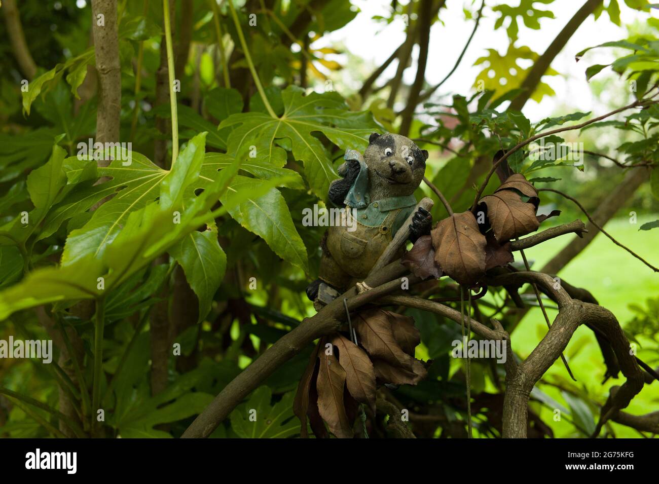 A plastic badger in a bush Stock Photo