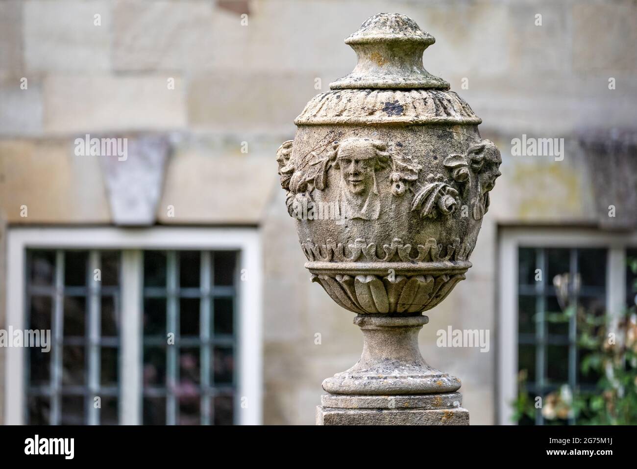 Close up of ornate carved stone vase or urn mounted on plinth in West Walk, Salisbury, Wiltshire, UK on 11 July 2021 Stock Photo