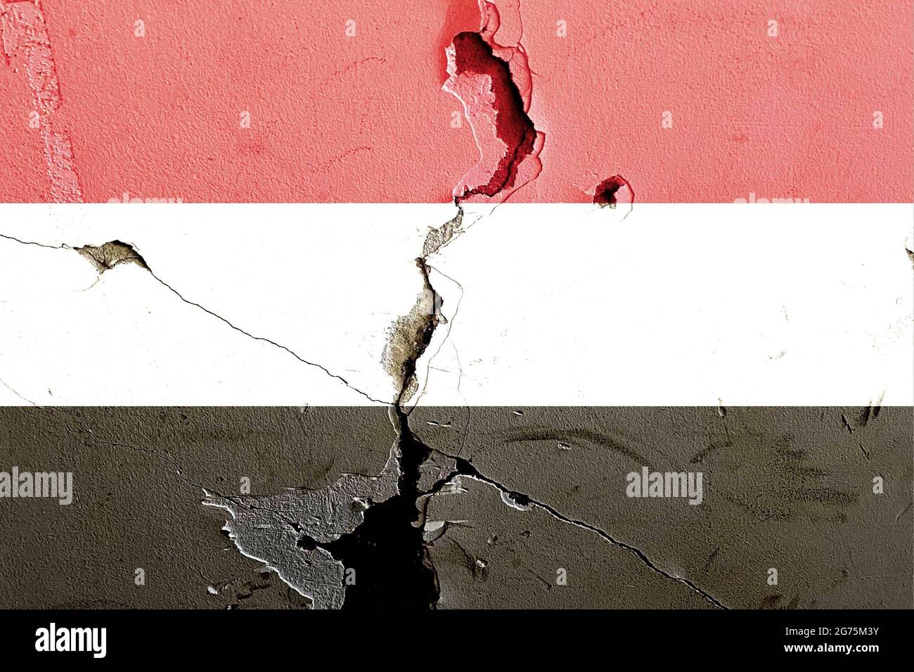 The national flag of Yemen painted on a weathered broken wall ...