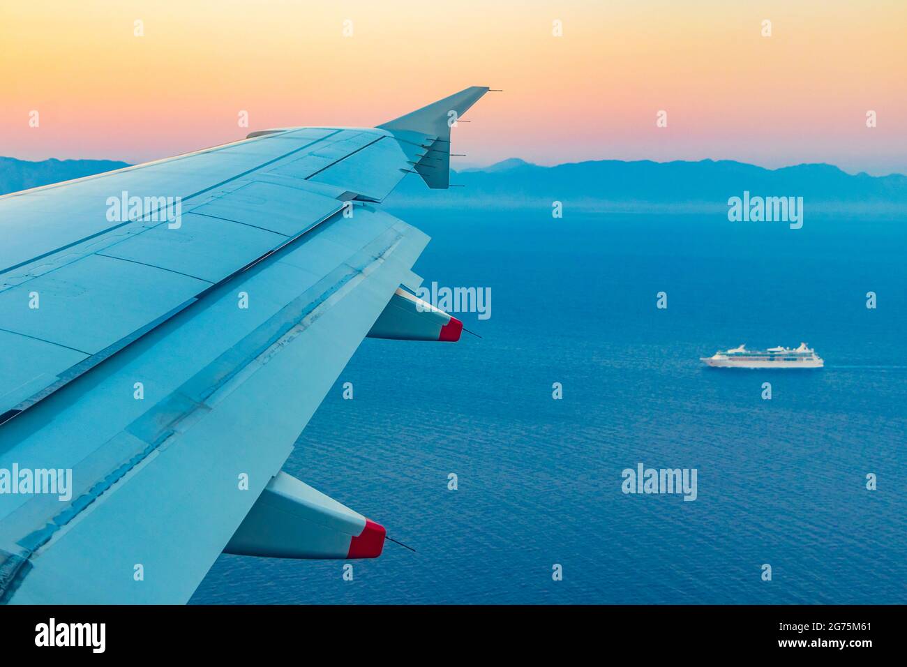 Flight over Rhodes in Greece and the sea during a colorful sunset. Stock Photo