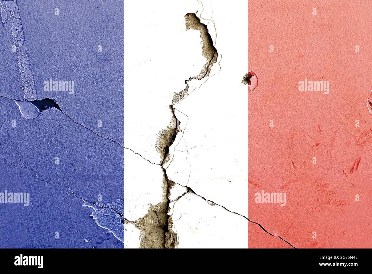 The national flag of France painted on a weathered broken wall ...