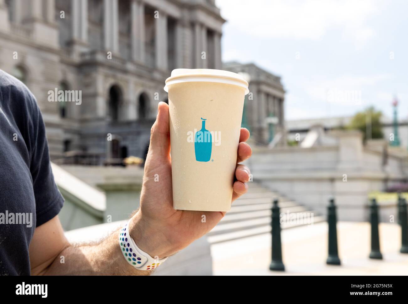 Blue Bottle Coffee Cup in Hand Stock Photo
