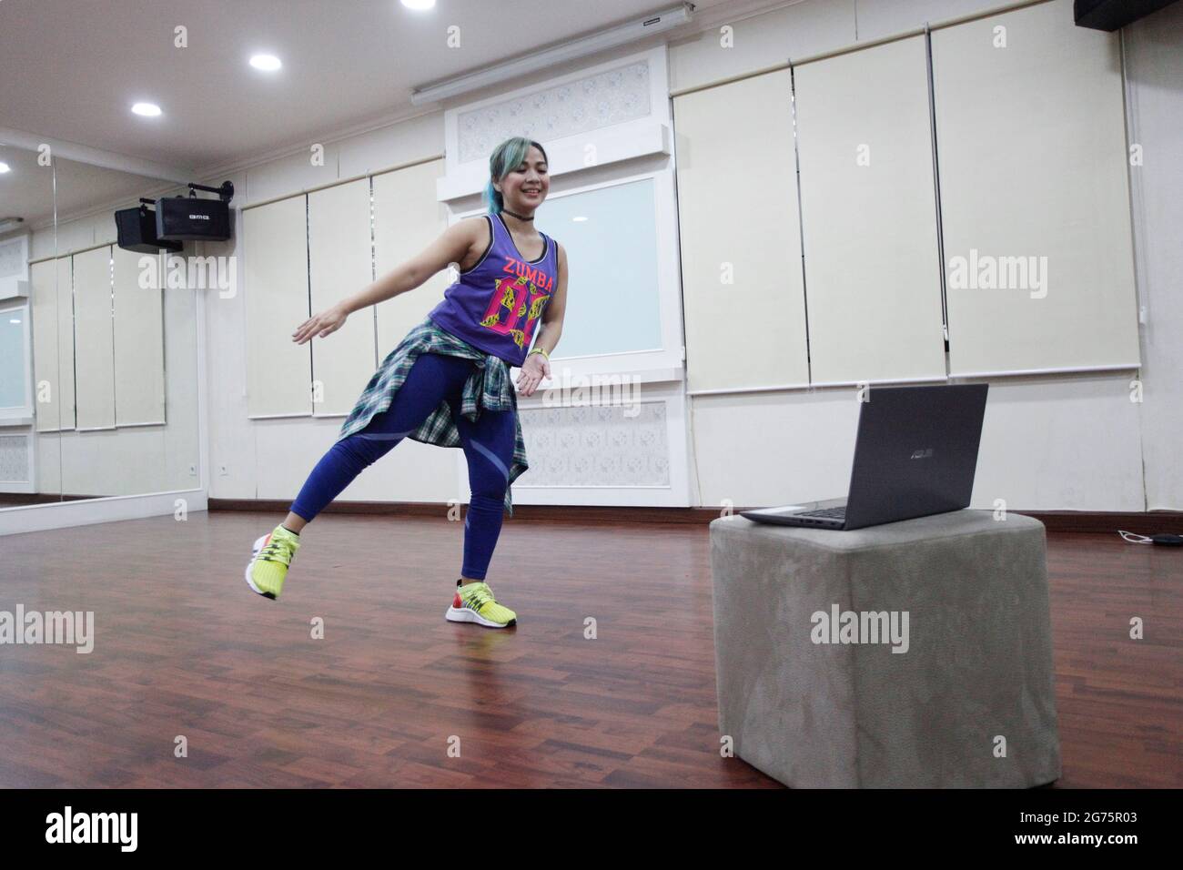 Bogor, Indonesia. 11th July, 2021. A Zumba instructor leads an online Zumba  fitness session over Zoom from her studios on July 11, 2021 in Bogor, West  Java, Indonesia. Zumba fitness is a