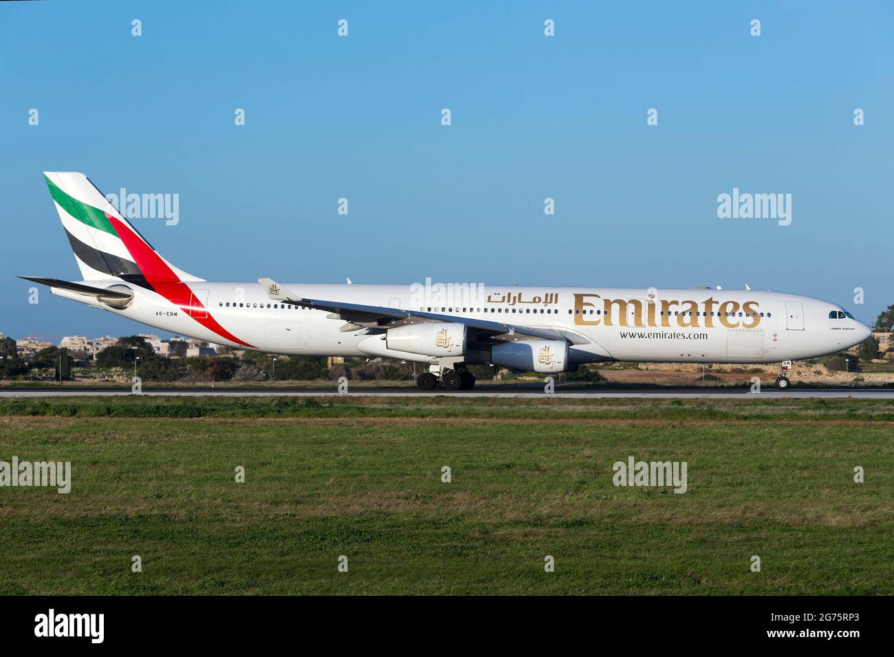 Emirates Airbus A340-313 [A6-ERM] departing to Dubai, after coming from a short flight from Tunis. Stock Photo