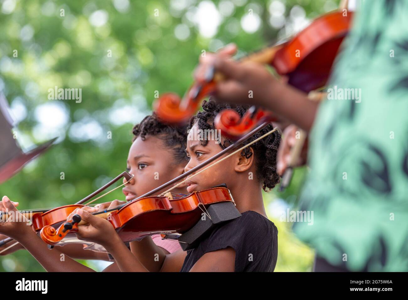 Detroit, Michigan - Students at Duke Ellington elementary school, part of the Detroit Public School system, play violin at a community arts and music Stock Photo