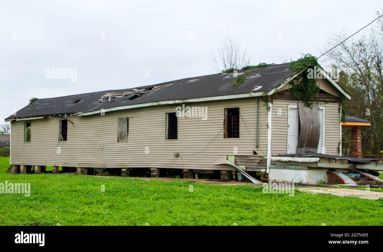 One of many homes destroyed by flooding in the Lower 9th Ward of New Orleans.  Missing roofing, broken windows, sagging with destroyed porch. Stock Photo
