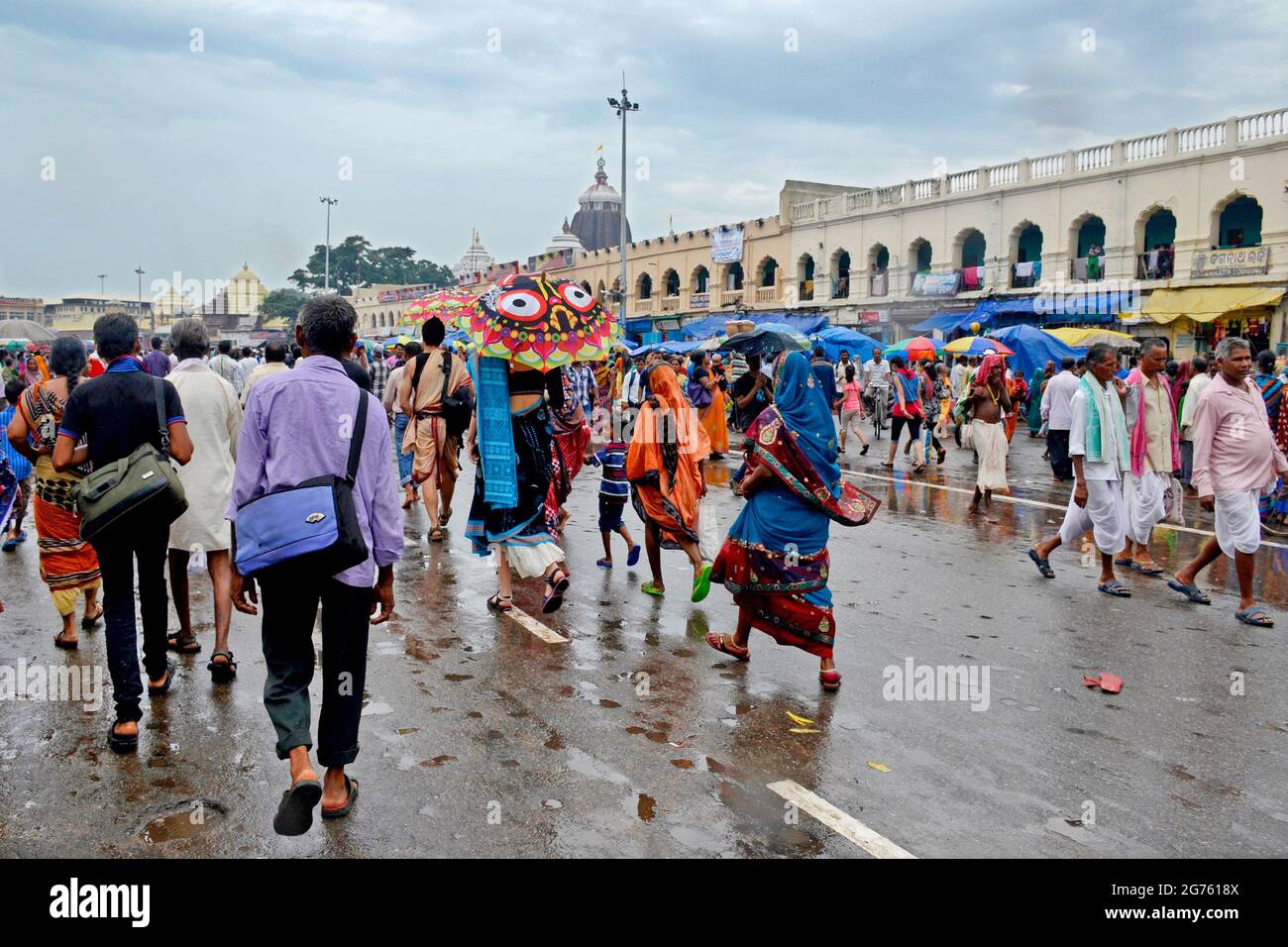 Pictures of rain soaked Puri city streets on the day of Rath Yatra. Sri Mandir is visible in the middle of the rain clouds in the background. Stock Photo