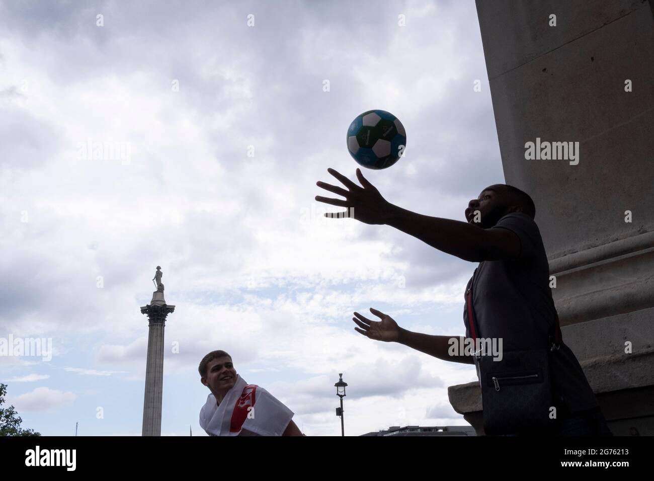 Hours before the England football team play an historic game against Italy the first time since 1966 that the English national team have played in a major mens' international football final, thousands of mainly young male supporters crowd without face coverings nor social distancing in Trafalgar Square, on 11th July 2021, in London, England. Stock Photo