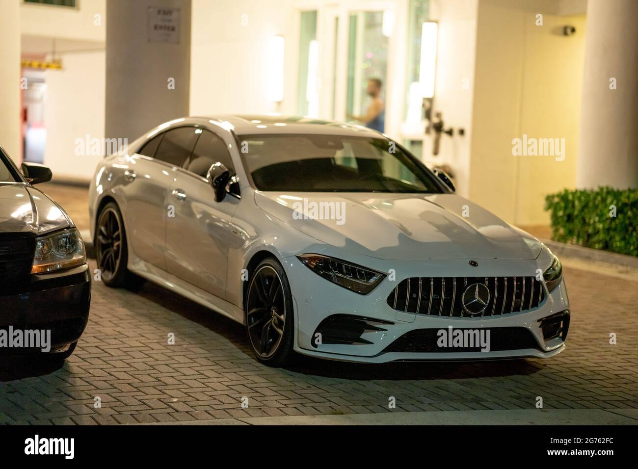 Photo of a sleek new Mercedes sedan parked in the city at night Stock Photo