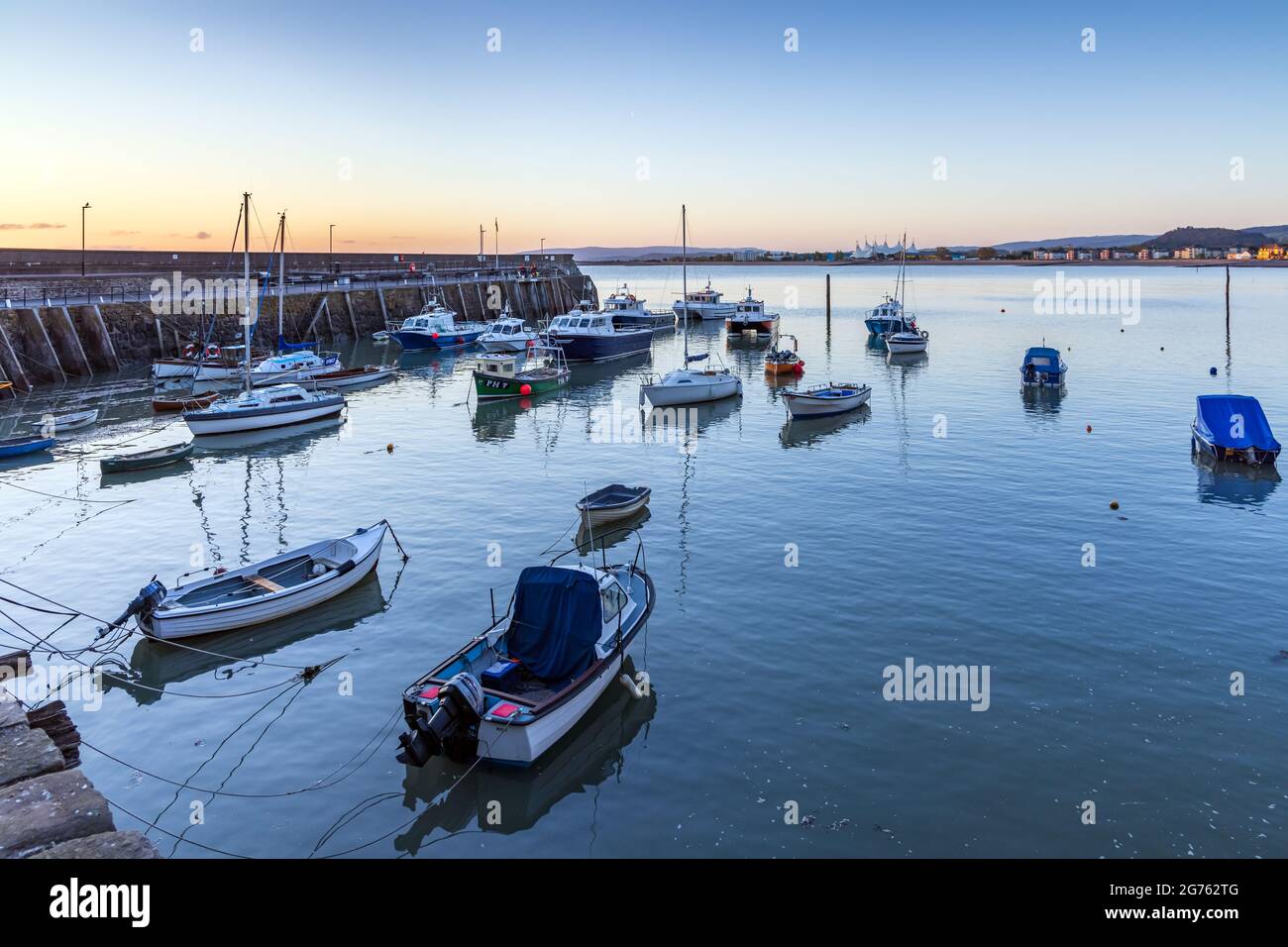 The old harbour at Minehead on the Somerset coast at sunrise. Stock Photo