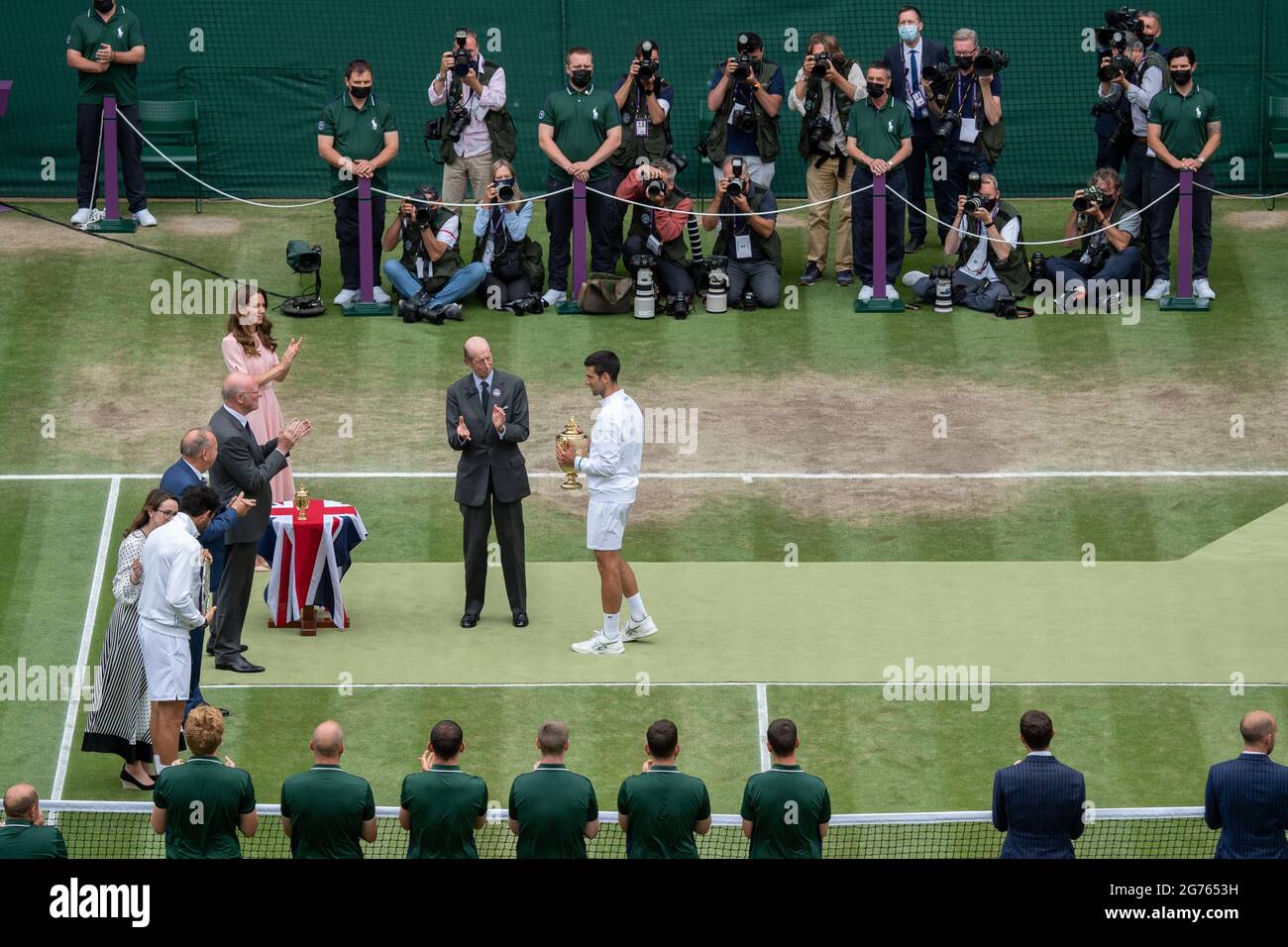 Novak Djokovic receives the mens' Singles Trophy from HRH The Duke of Kent, President of the All England Lawn Tennis Club, after his victory against Matteo Berrettini in the final on centre court on day thirteen of Wimbledon at The All England Lawn Tennis and Croquet Club, Wimbledon. Picture date: Sunday July 11, 2021. Stock Photo