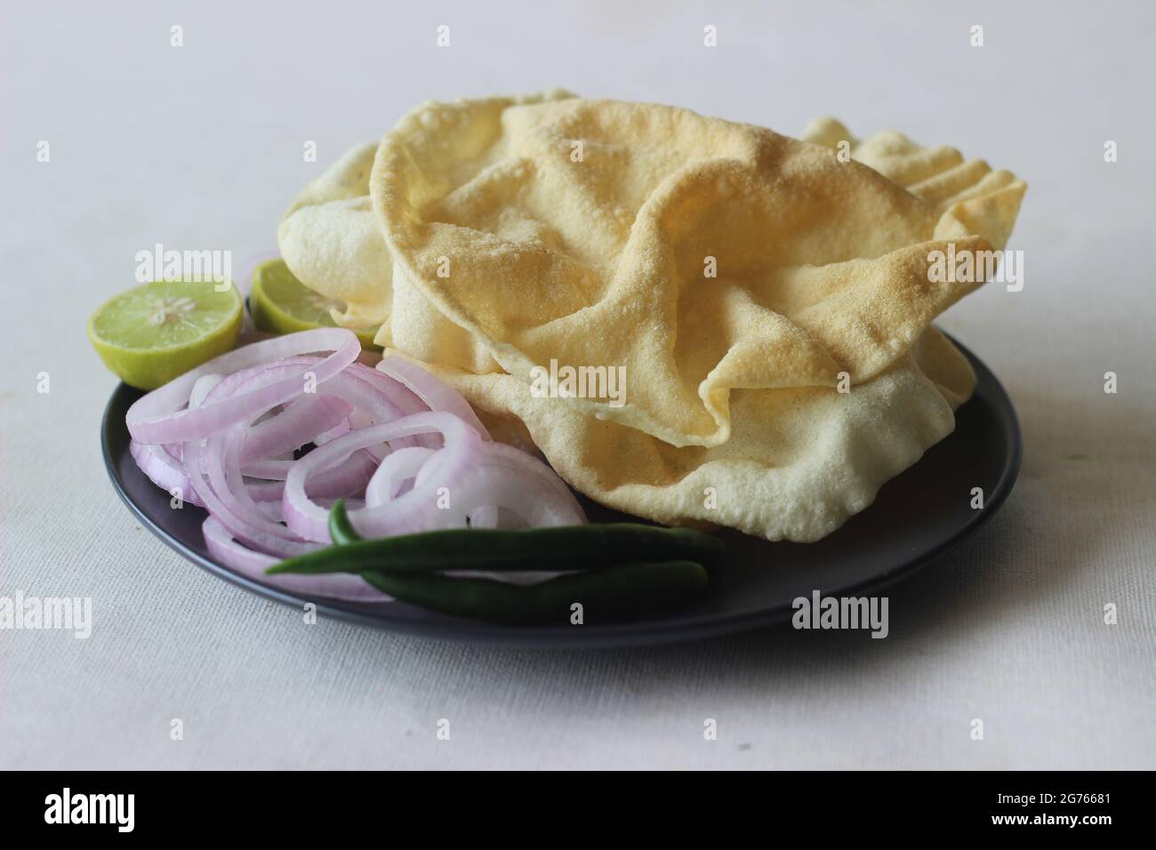 A papadum also called papad is a thin, crisp, round flatbread from