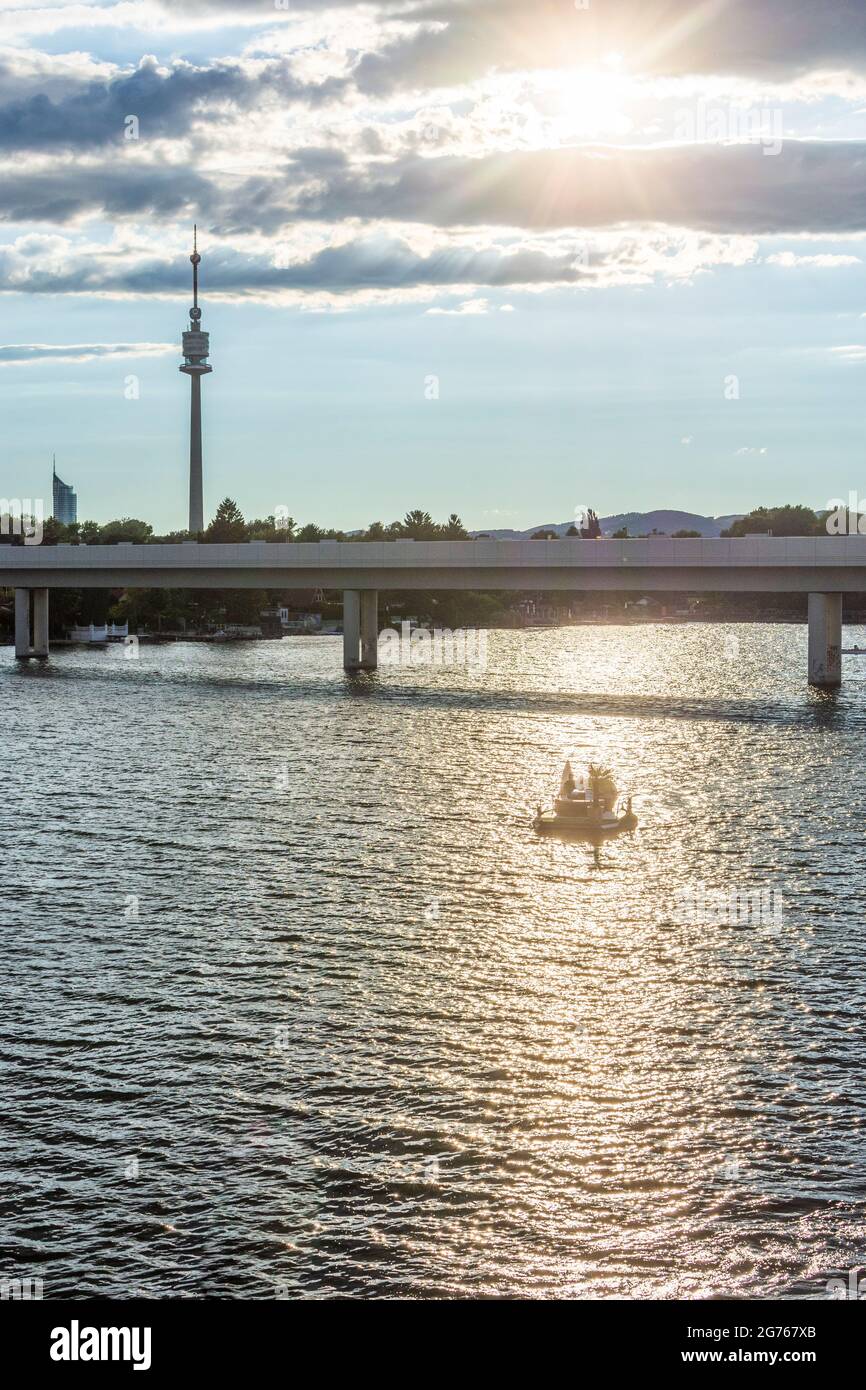 Wien, Vienna: late sun at river Alte Donau (Old Danube), boats, bridge of subway line U1, tower Donauturm in 22. Donaustadt, Wien, Austria Stock Photo