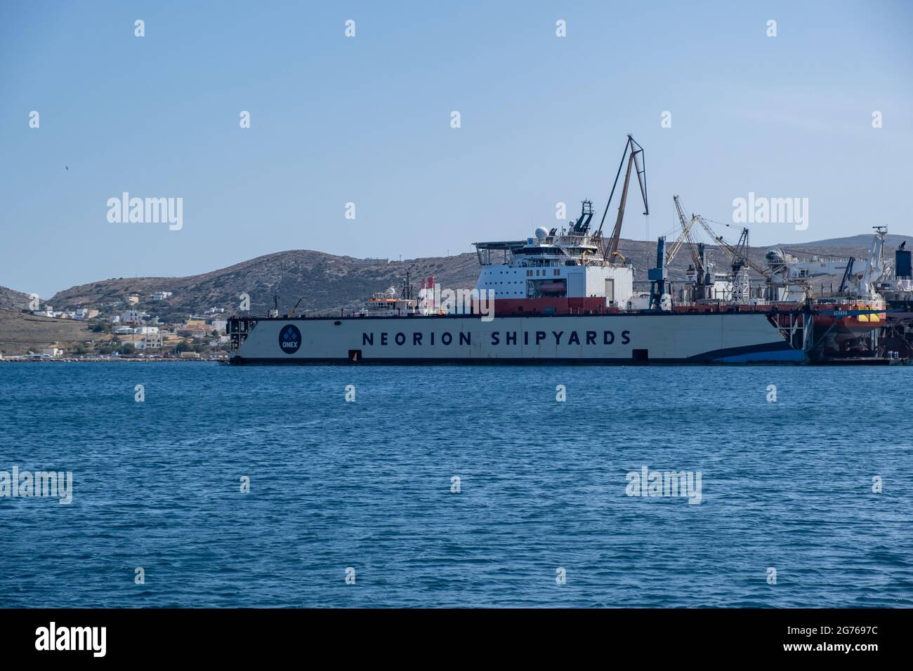 Syros island, Cyclades, Greece. May 26, 2021. Neorion shipyard  harbour and industrial plant at Ermoupolis capital of Siros or Syra town. Ships, crane Stock Photo