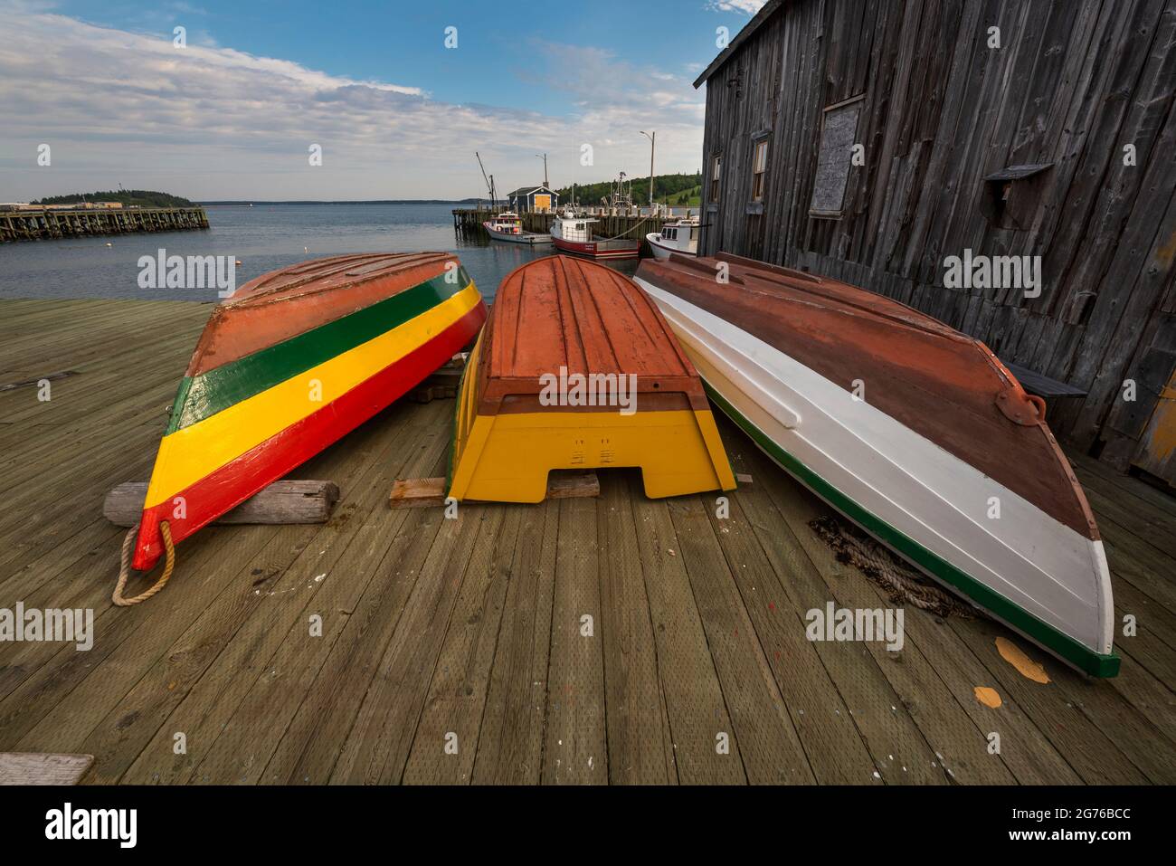 Boats dry after painting outside a boatbuilder's on the bay in