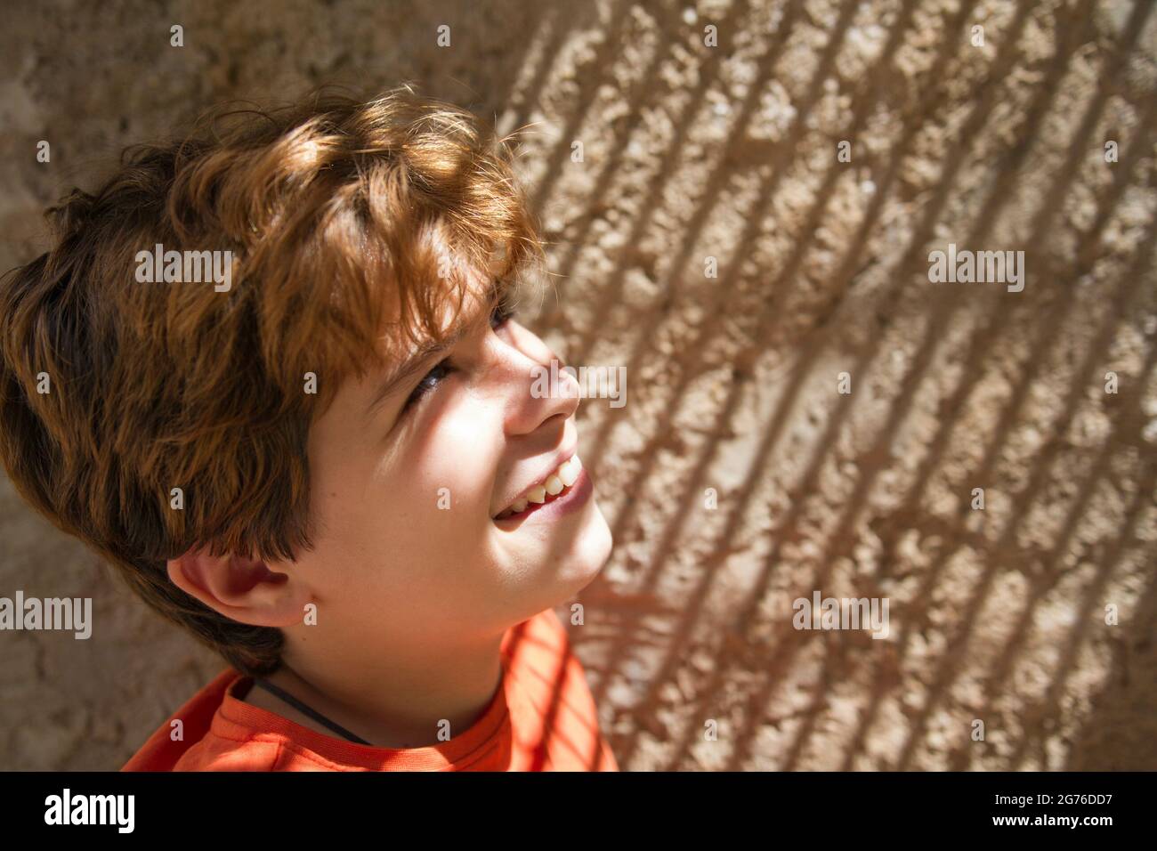 A blonde Spanish boy looking up with sunlight on his face Stock Photo -  Alamy