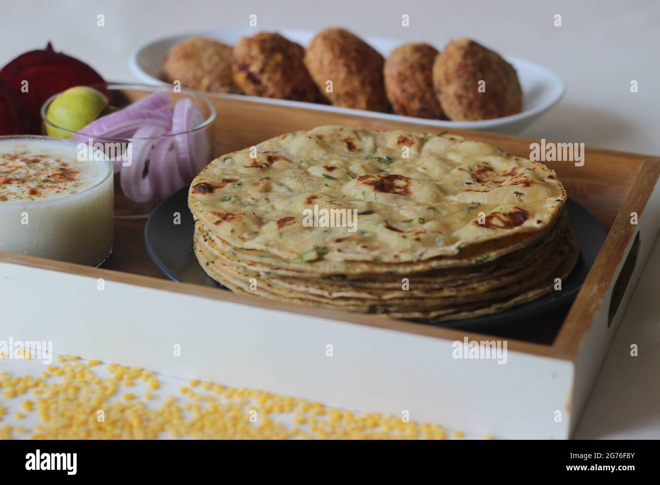 A high protein Indian flat bread with whole wheat and lentils. Popularly known as moong dal paratha in many parts of India. Served with vegetarian bee Stock Photo