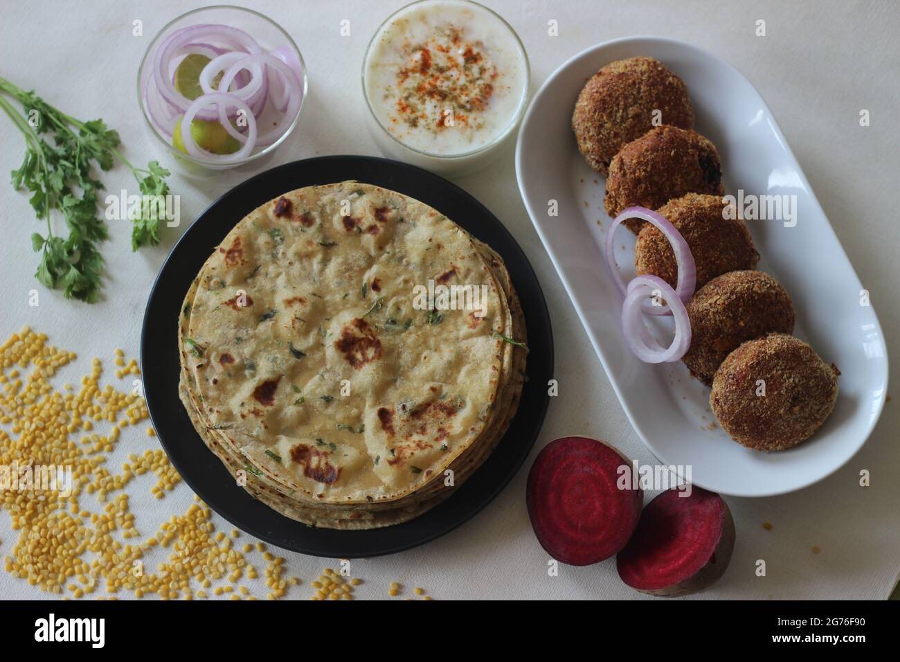 A high protein Indian flat bread with whole wheat and lentils. Popularly known as moong dal paratha in many parts of India. Served with vegetarian bee Stock Photo