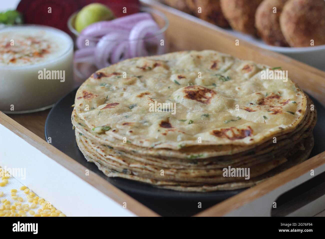 A high protein Indian flat bread with whole wheat and lentils. Popularly known as moong dal paratha in many parts of India. Served with vegetarian bee Stock Photo