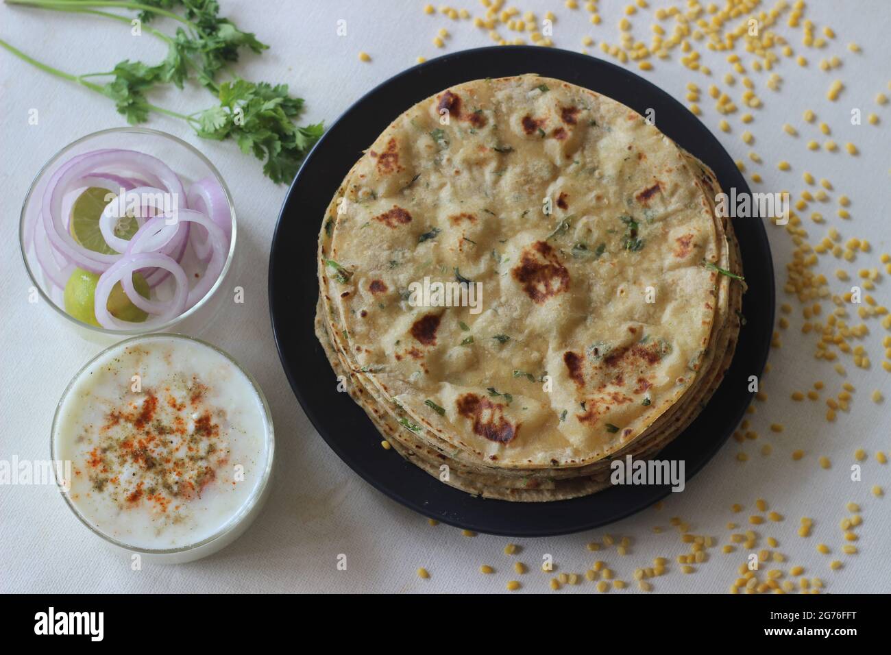 A high protein Indian flat bread with whole wheat and lentils. Popularly known as moong dal paratha in many parts of India. Shot on white background. Stock Photo