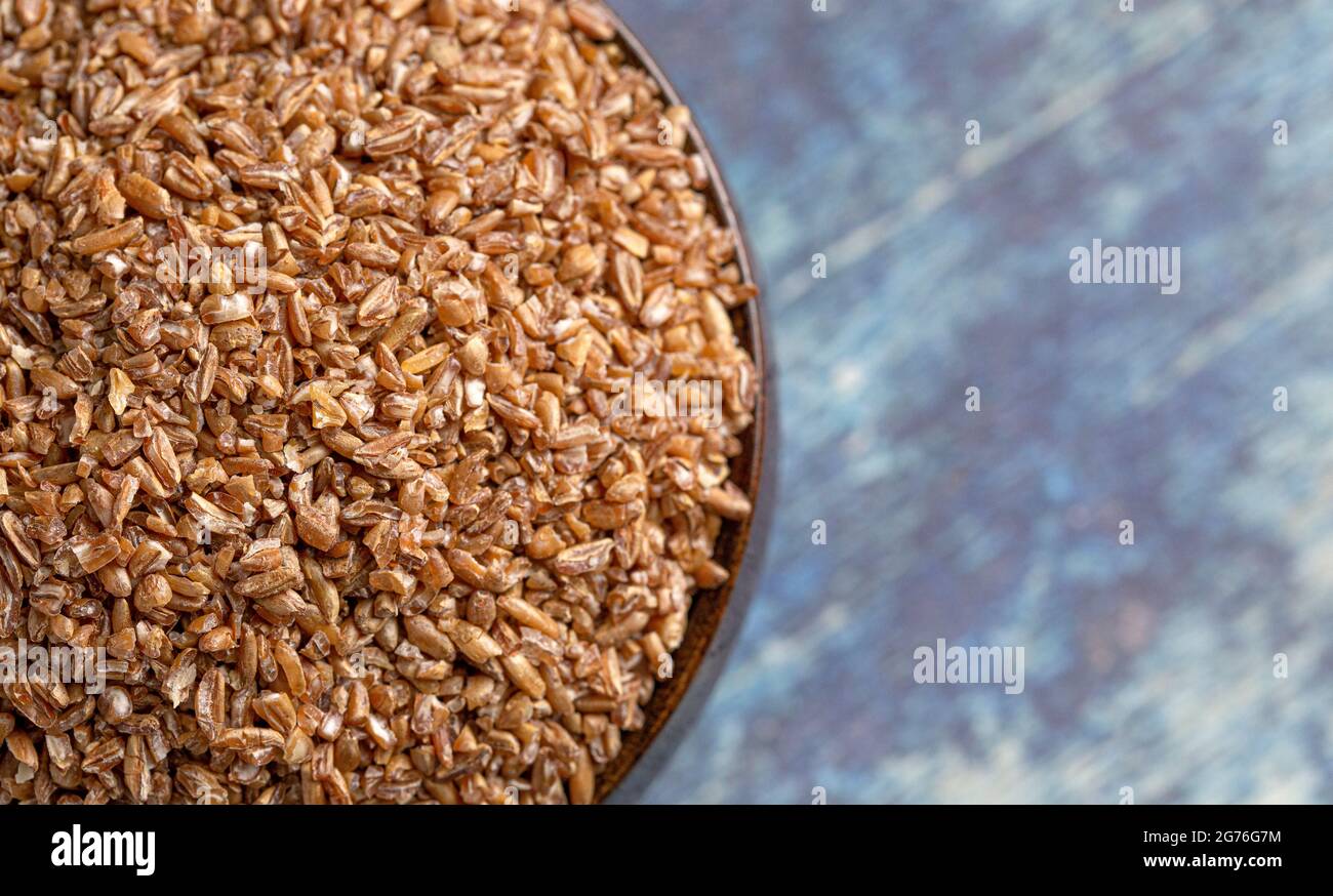 Bulgerty Eatable Bowl Bulgur Wheat on a Rustic Blue Table Stock Photo - Alamy