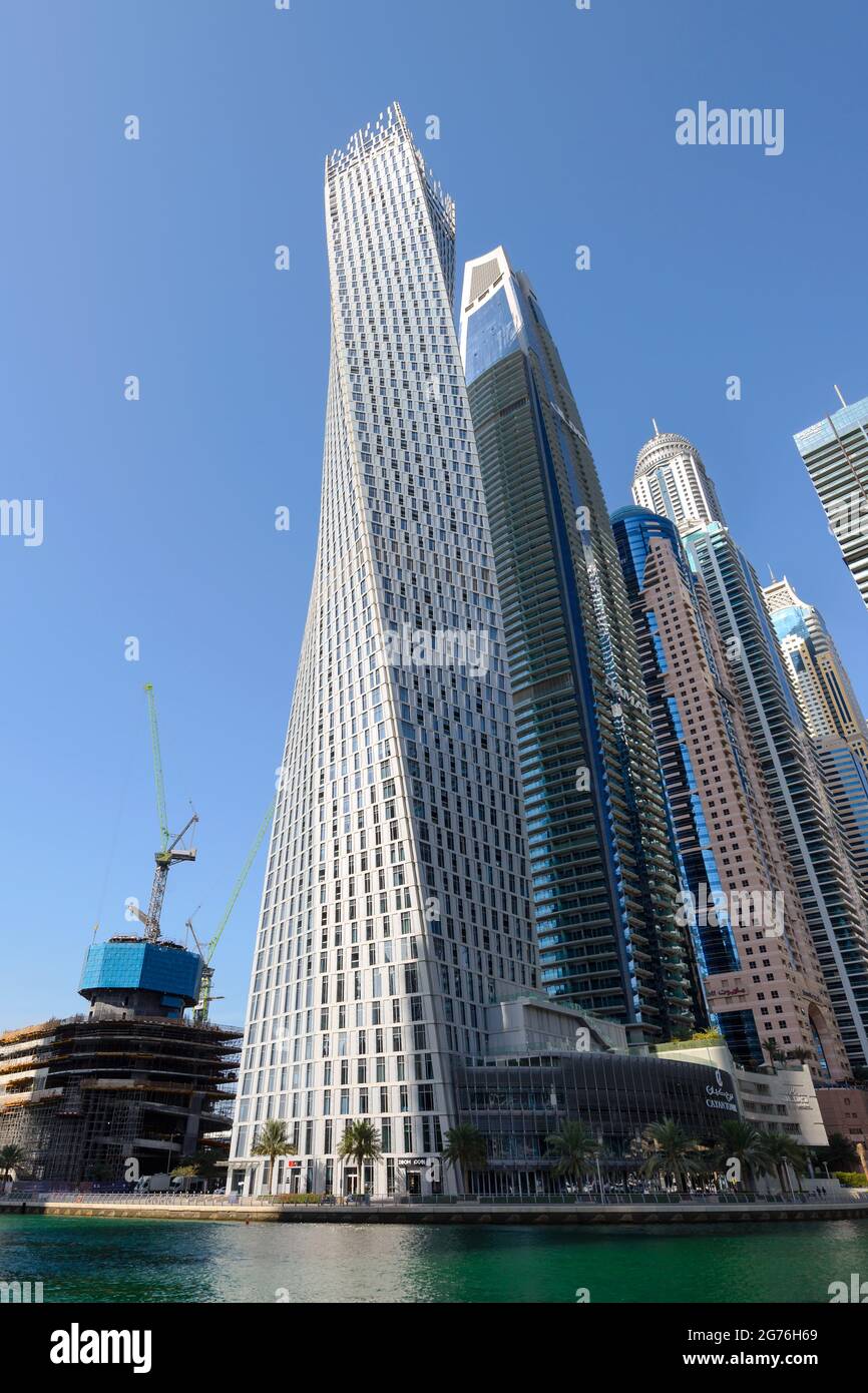Cayan Tower, a turning skyscraper built in Dubai Marina, UAE. Residential building formerly know as Infinity Tower. Stock Photo