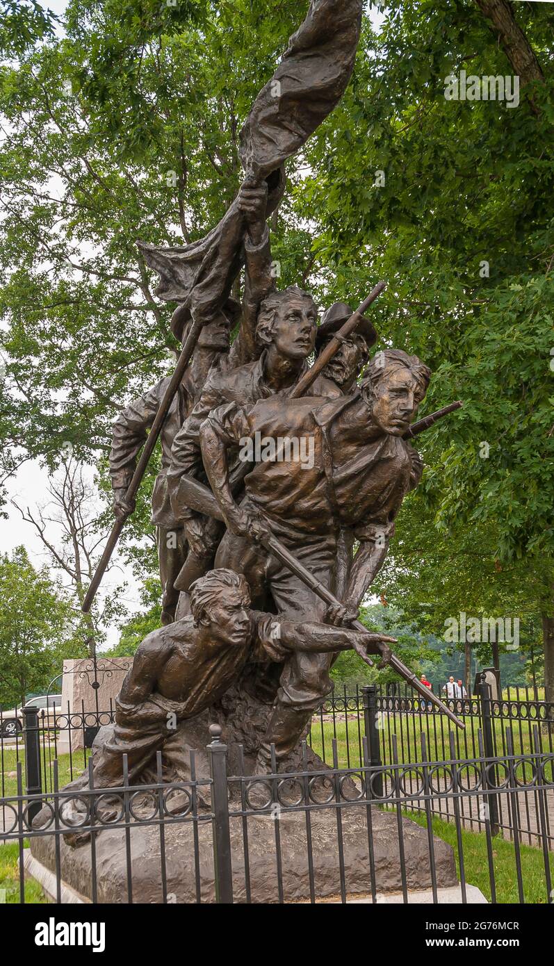 Gettysburg, PA, USA - June 14, 2008: Battlefield monuments. Closeup of the 5 attacking soldiers on the North Carolina State monument with green foliag Stock Photo