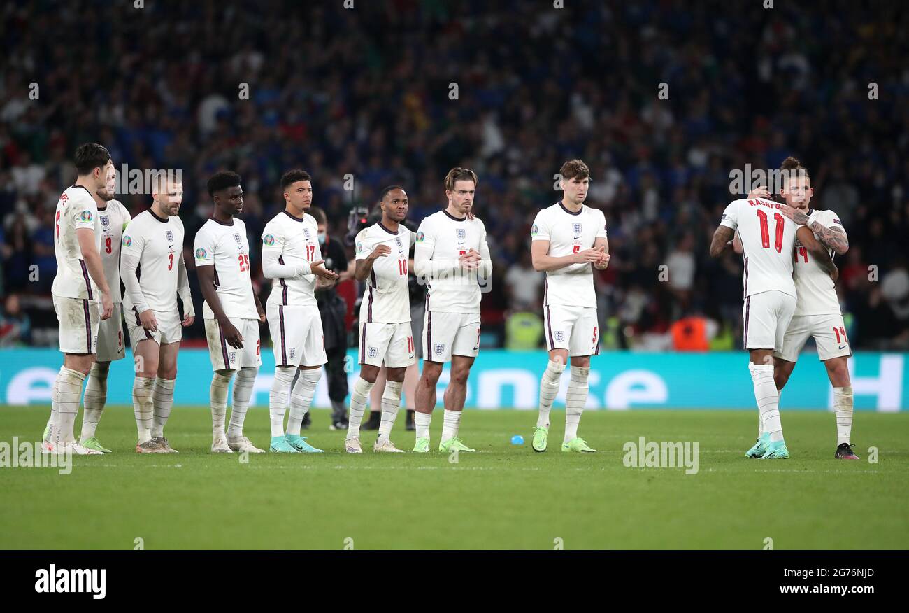 England's Marcus Rashford (2nd right) is consoled by Kalvin Phillips after missing in the penalty shoot-out during the UEFA Euro 2020 Final at Wembley Stadium, London. Picture date: Sunday July 11, 2021. Stock Photo