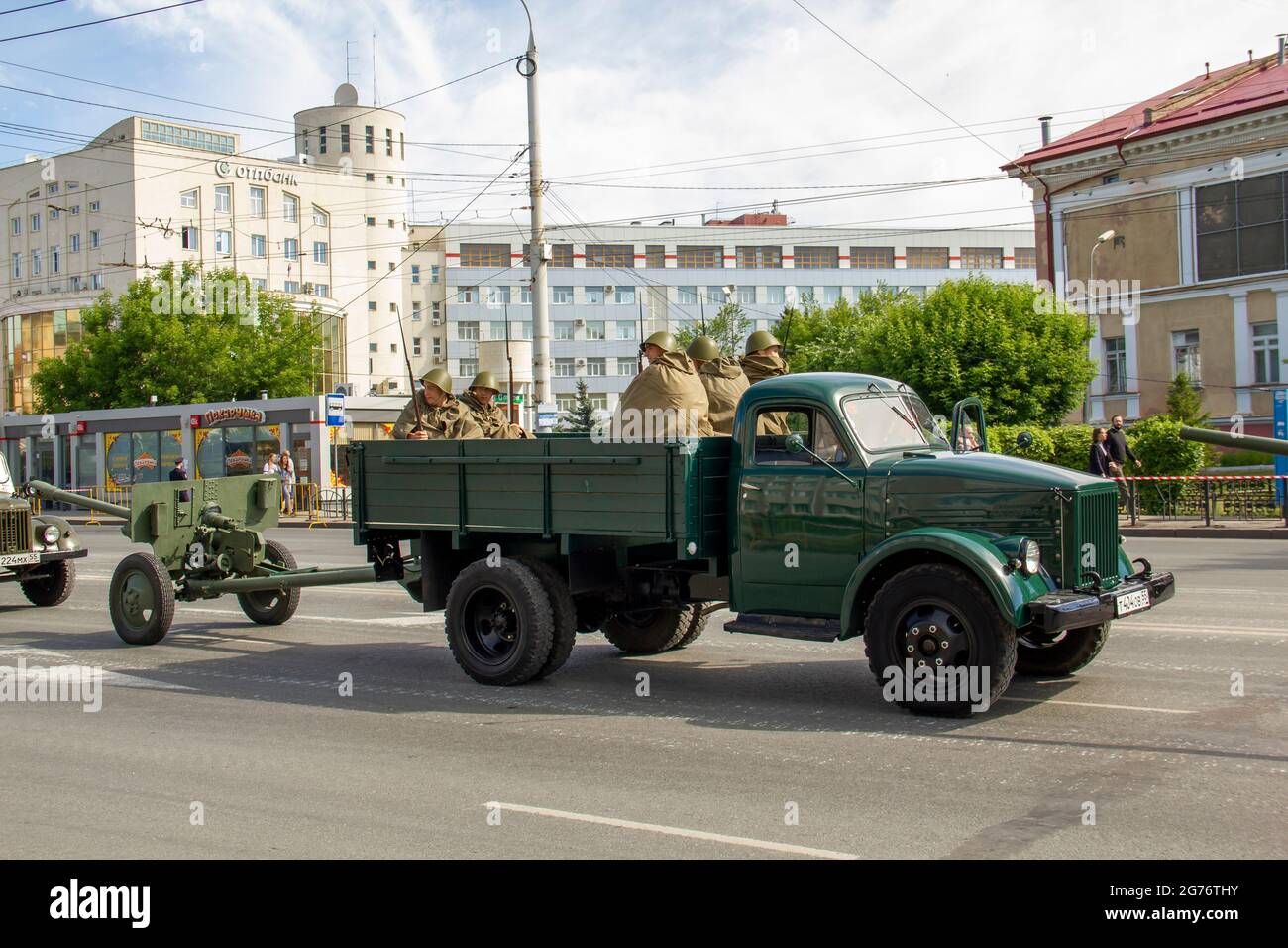Omsk, Russia. 24 June, 2020. GAZ-51 military vehicle with soldiers and a light cannon are moving in a festive column. Parade of military equipment in Stock Photo
