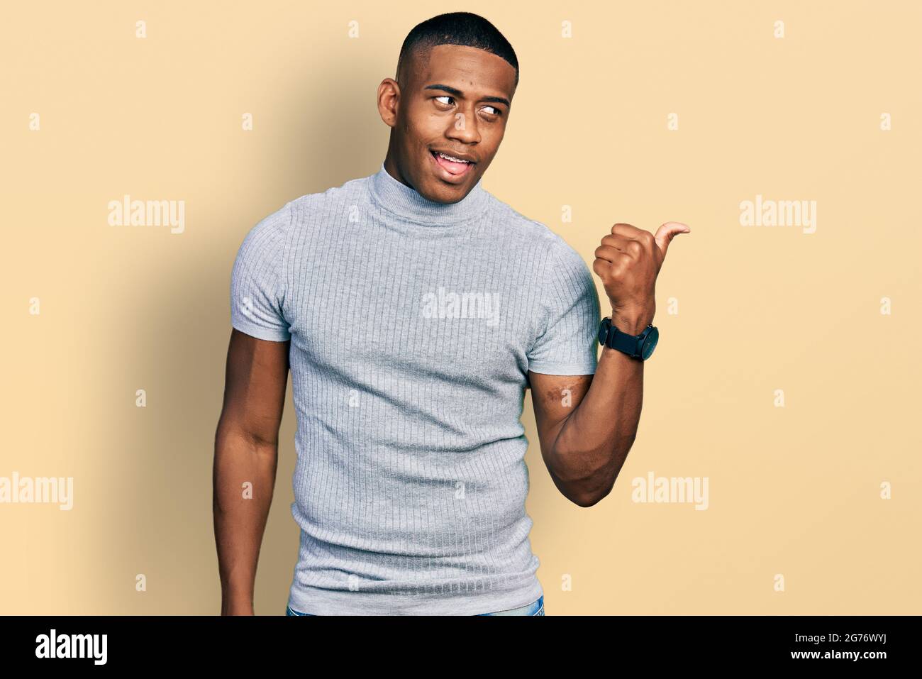 Young black man wearing casual t shirt smiling with happy face looking ...