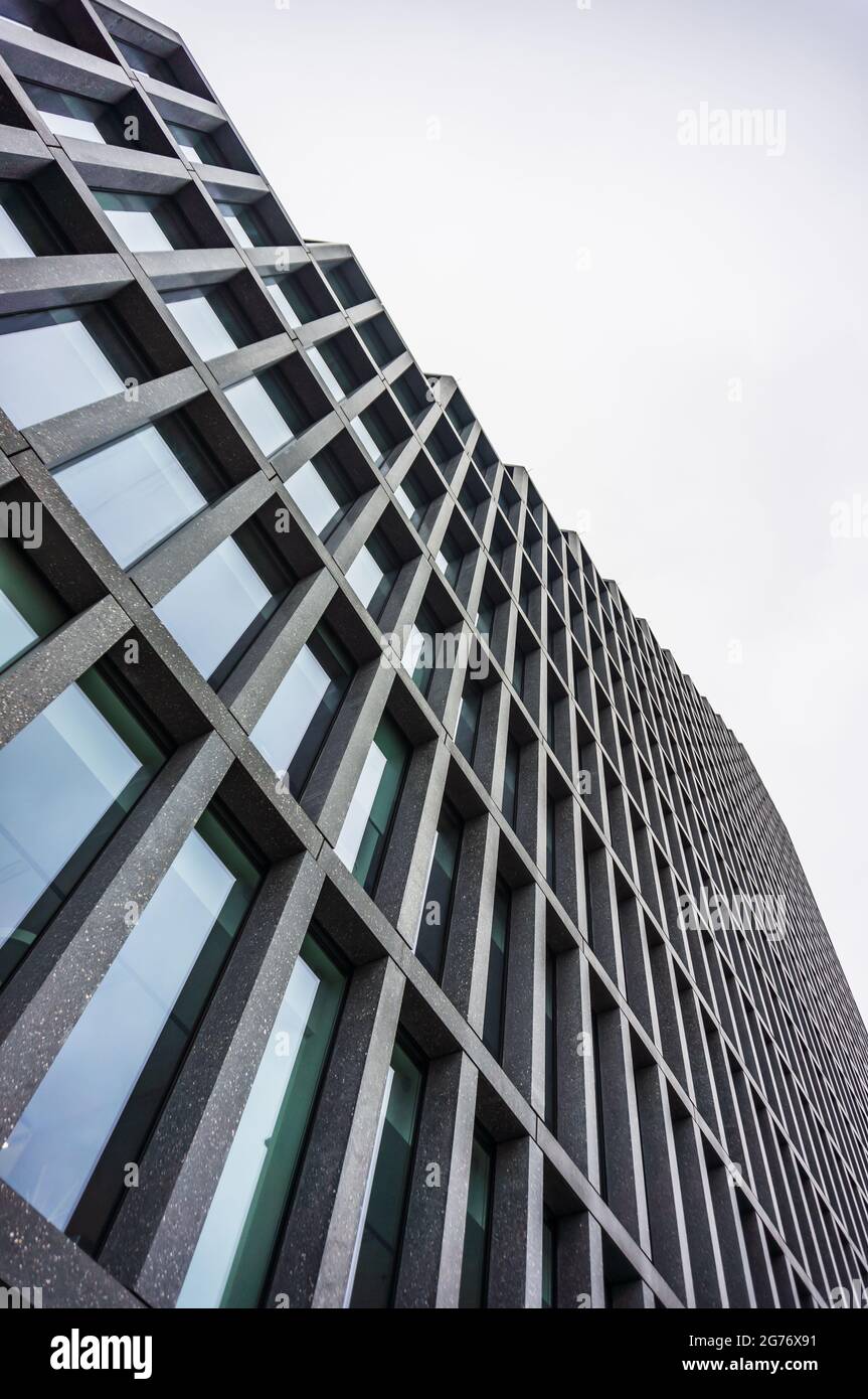 POZNAN, POLAND - Nov 16, 2018: A low angle shot of the modern Baltyk office building with many windows in the Roosevelta street Stock Photo