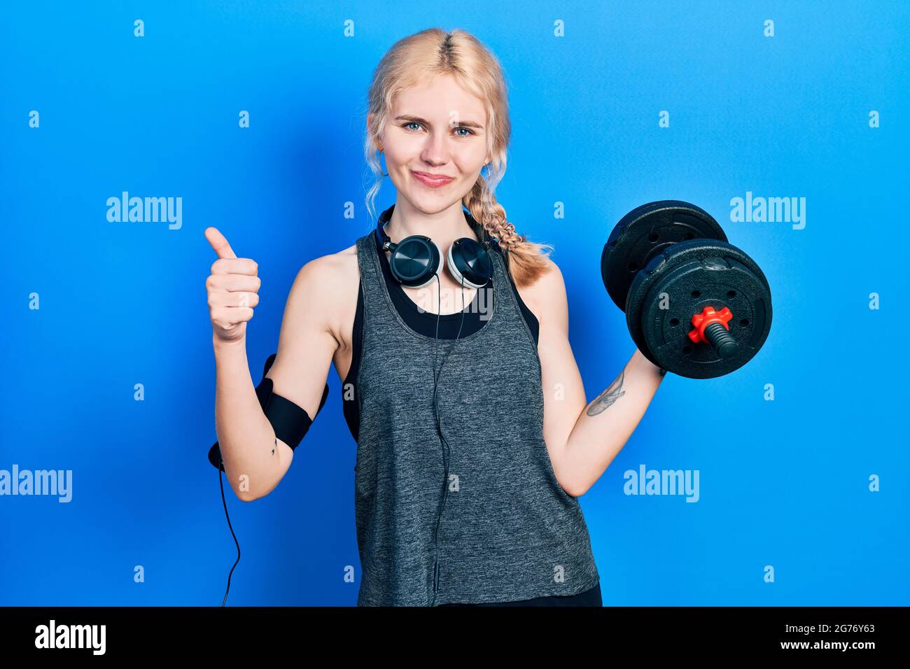 Beautiful caucasian sports woman with blond hair wearing sportswear ...