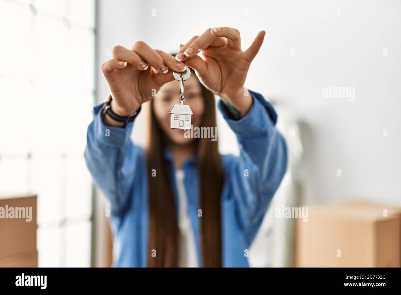 Young chinese girl smiling happy holding key of new home Stock Photo ...