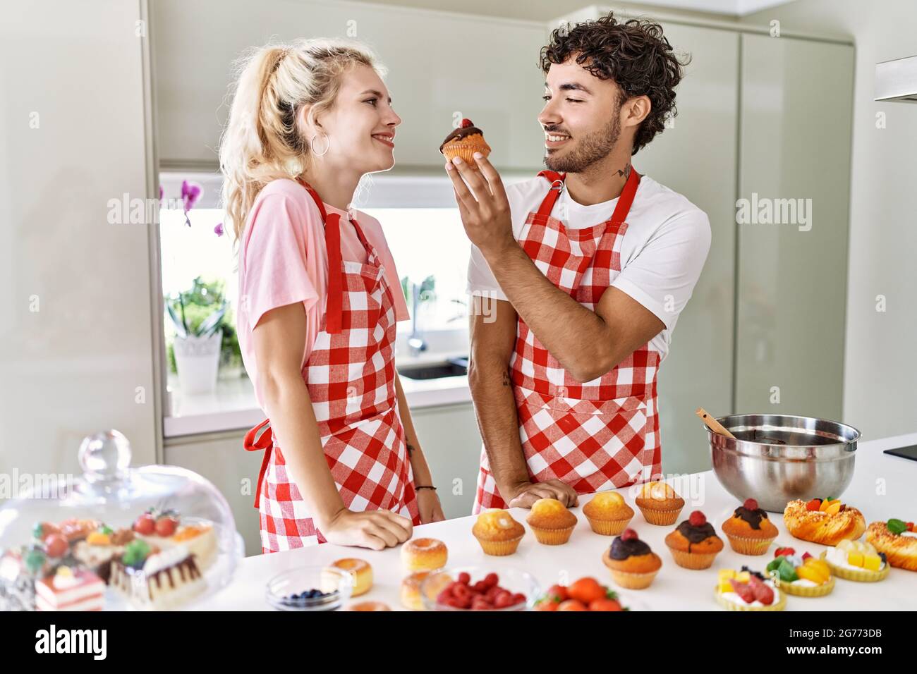 Young couple smiling happy cooking sweets at kitchen Stock Photo - Alamy