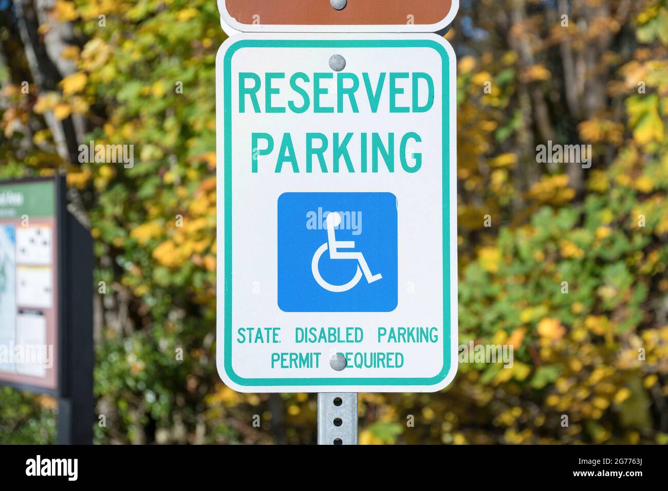 Reserved parking for a person with disability signage on a metal post at Tacoma in Washington Stock Photo