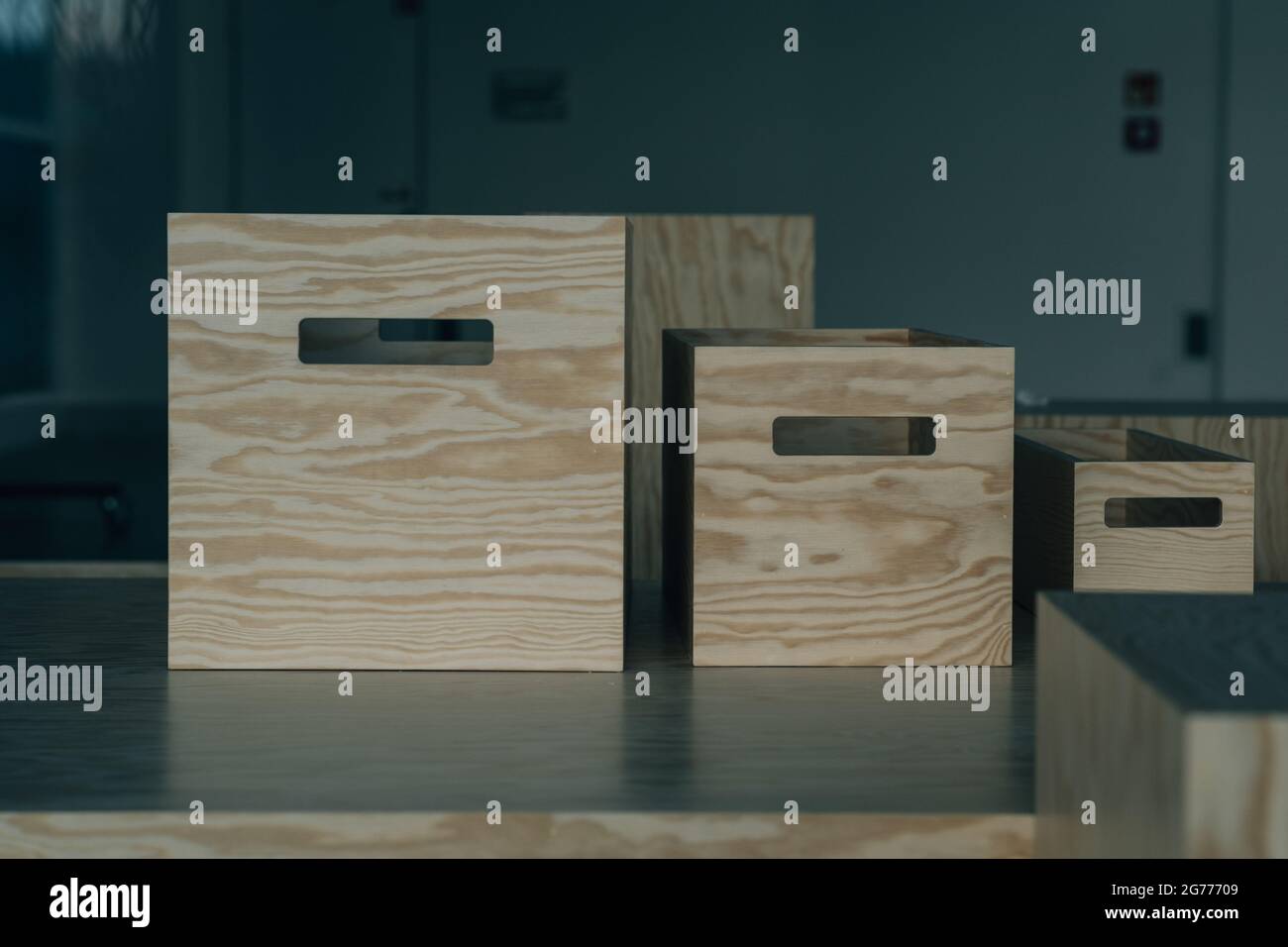 Descending Box An arrangement of wooden boxes in decreasing order on a reflective ...