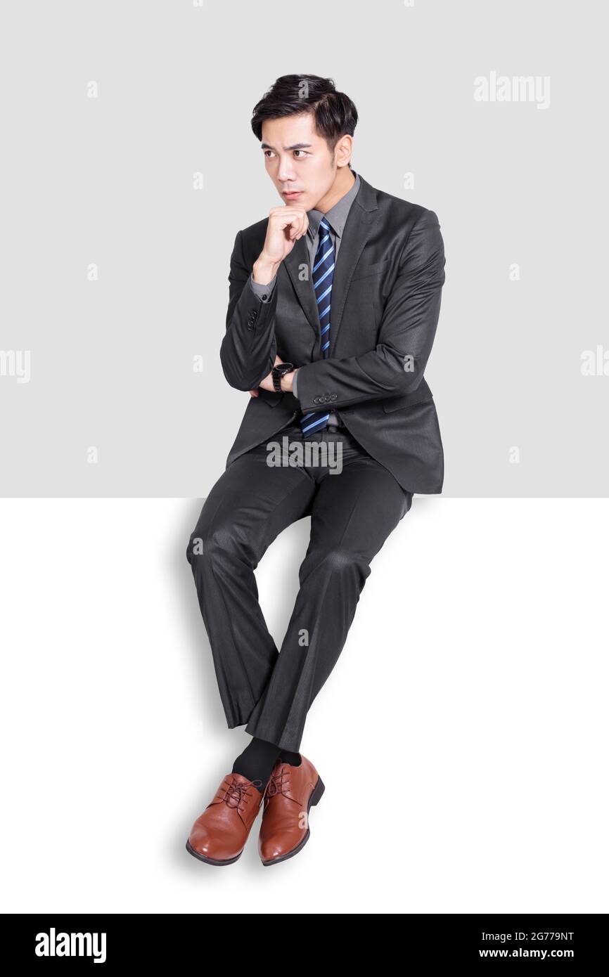 Young handsome businessman sitting and thinking the problem Stock Photo