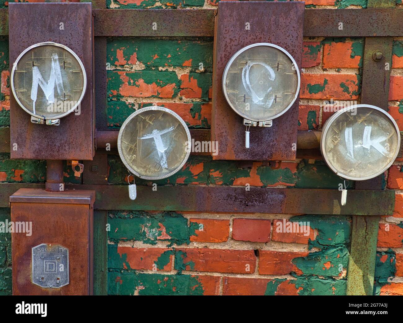 Abandoned electrical service meter boxes on abandoned building Stock Photo