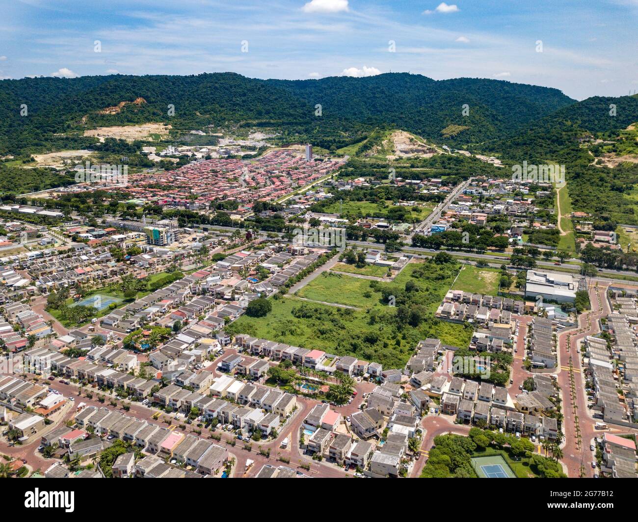 Aerial drone view of gated communities outside Guayaquil City, Ecuador and the main highway going to Via a la Costa. Shot from over houses and homes. Stock Photo