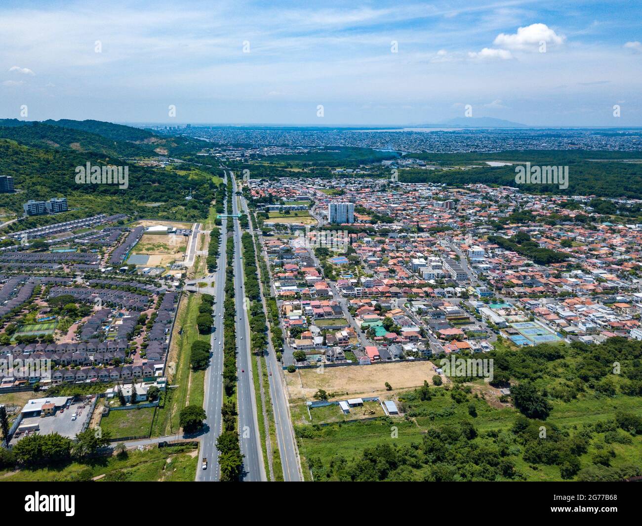 Aerial drone view of gated communities outside Guayaquil City, Ecuador and the main highway going to Via a la Costa. Shot from over houses and homes. Stock Photo
