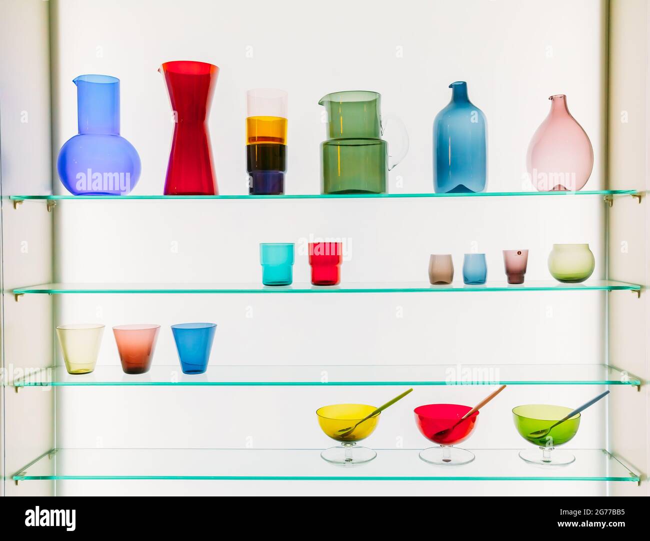 Assorted Different Sizes And Shapes Of Colorful Glassware On Shelves. Vases, Pitchers, Jugs, Glasses. Stock Photo
