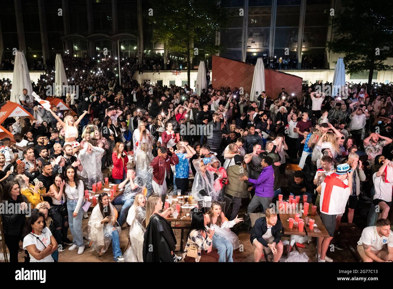 Manchester, UK. 11th July, 2021. Intense scenes down Spinningfields during the Euro2020 final which saw England get beaten by Italy during penalties. Football fans descended into the city early to try and catch the game wherever they could.ÊAndy Barton/Alamy Live News Credit: Andy Barton/Alamy Live News Stock Photo