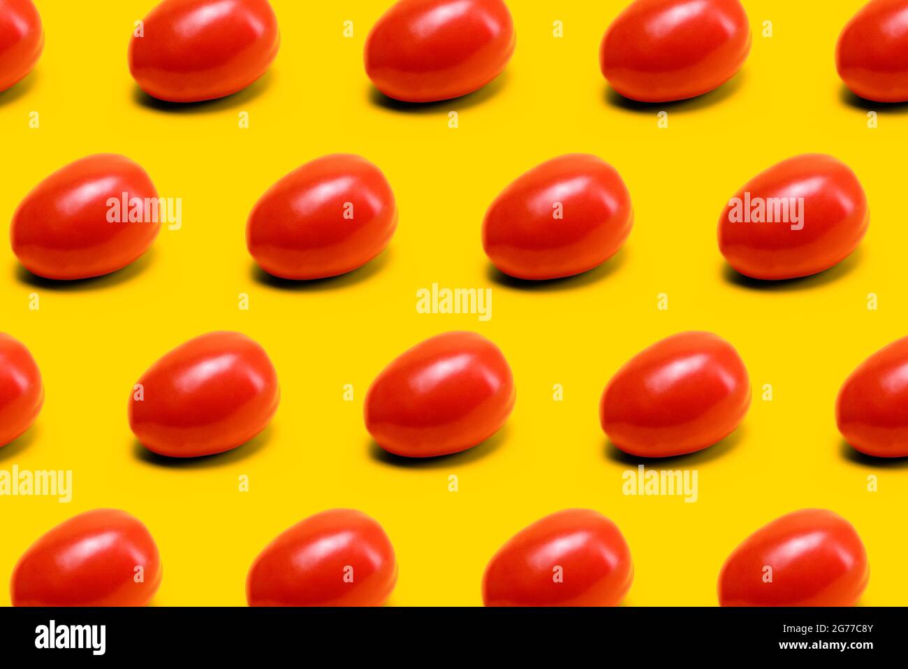 red mexican tomato, tomatoes pattern on yellow background Stock Photo