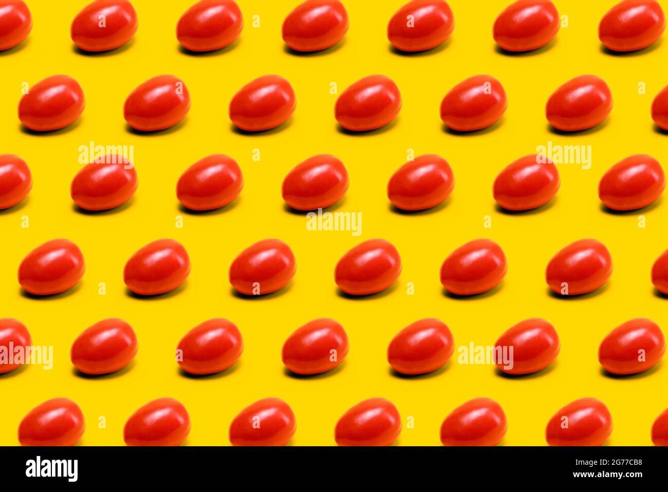 red mexican tomato, tomatoes pattern on yellow background Stock Photo