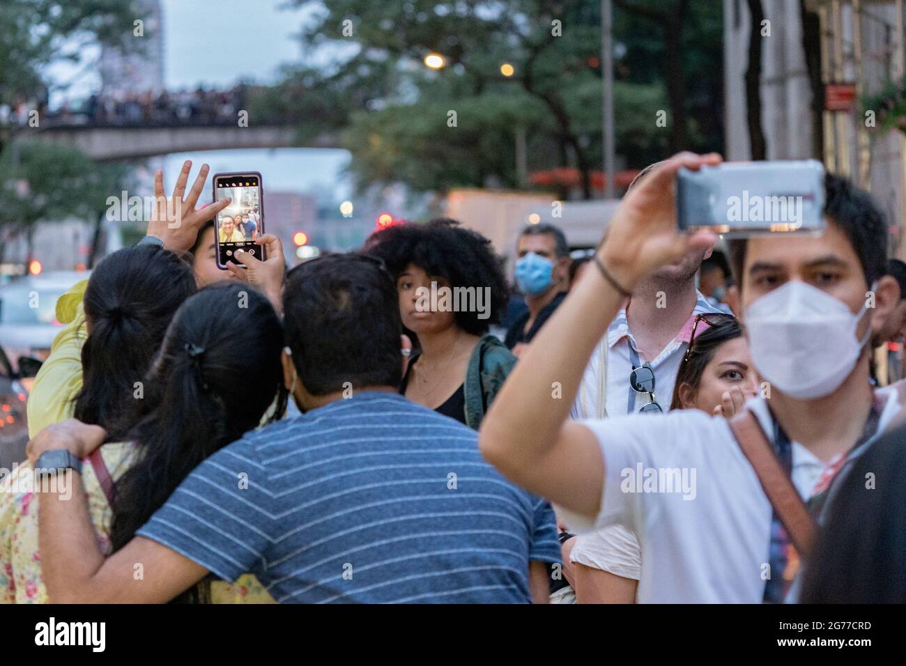 Viewers gather to watch and photograph in Manhattan during the