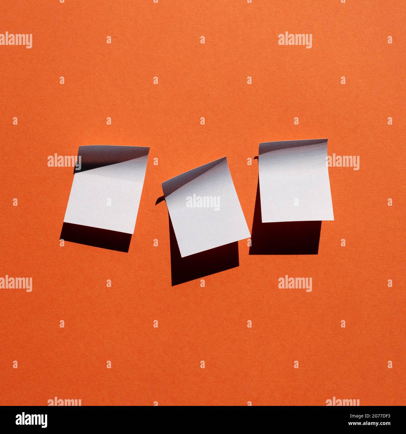 Blue sticky note paper on red background. copy space Stock Photo