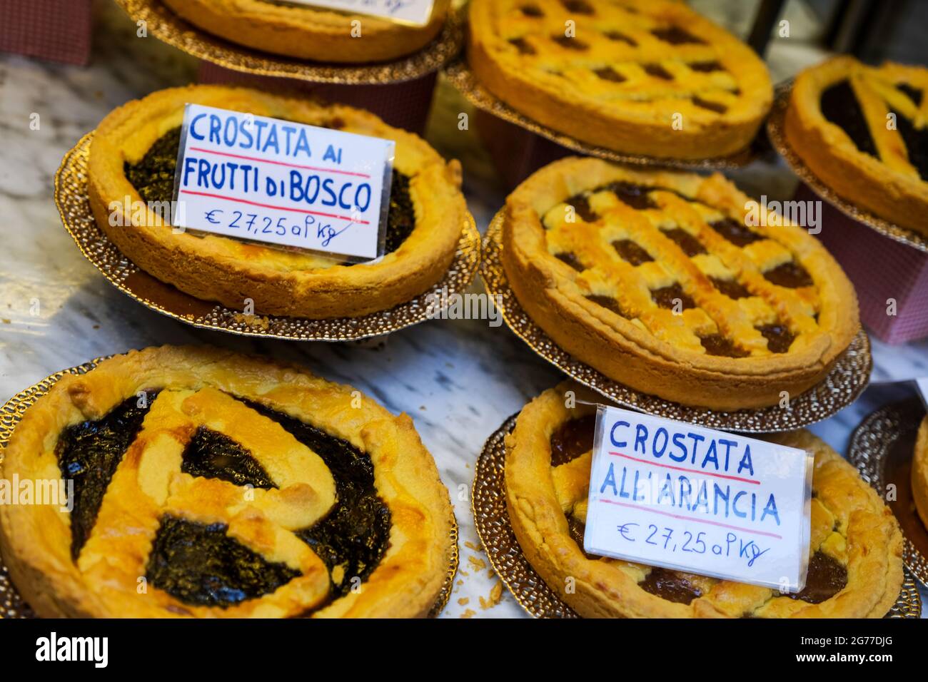 A variety of fruit pies displayed in a shop window in Bologna Italy Stock Photo